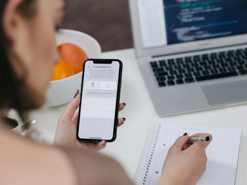 Mobile Phone With Laptop In The Background