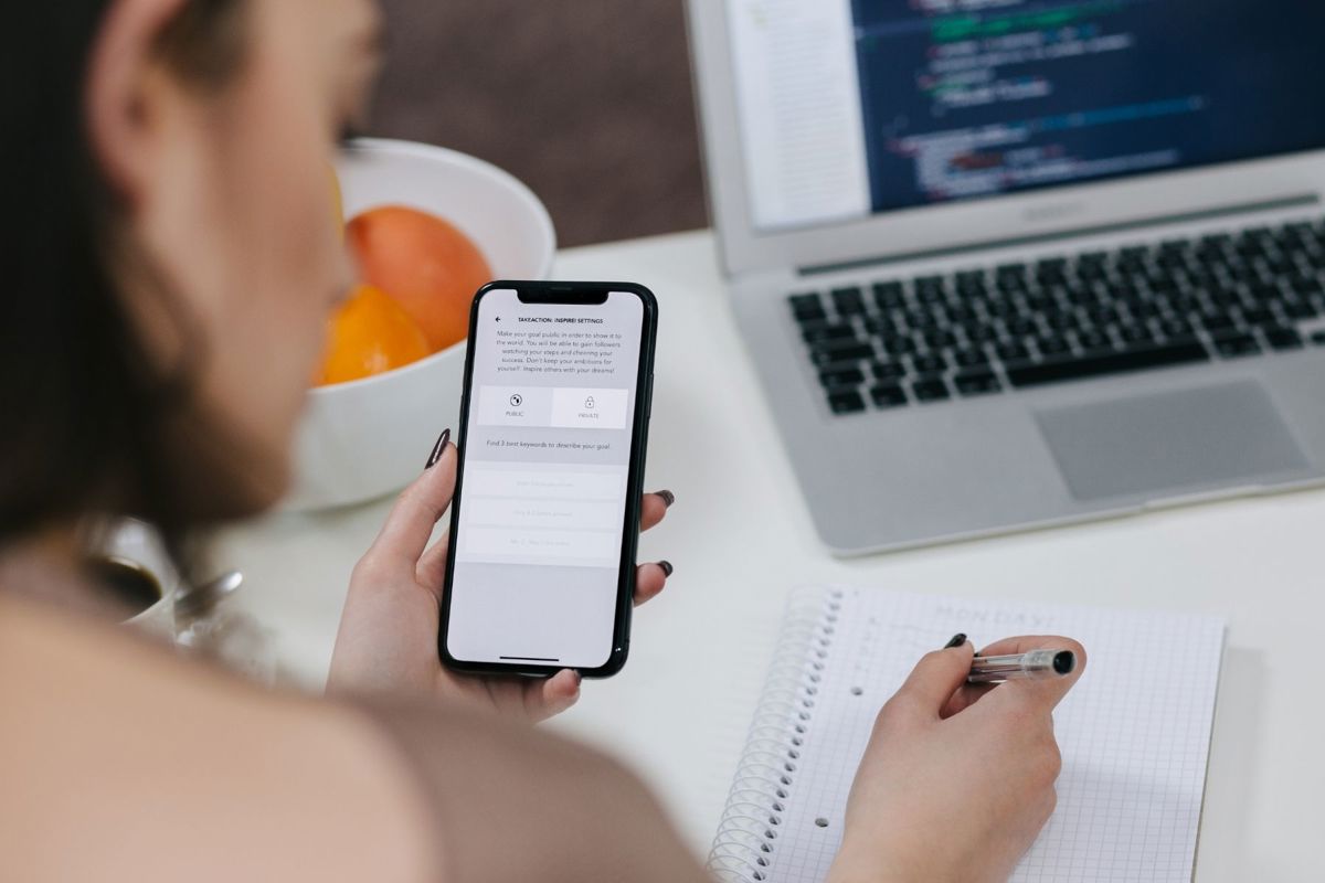 Mobile Phone With Laptop In The Background